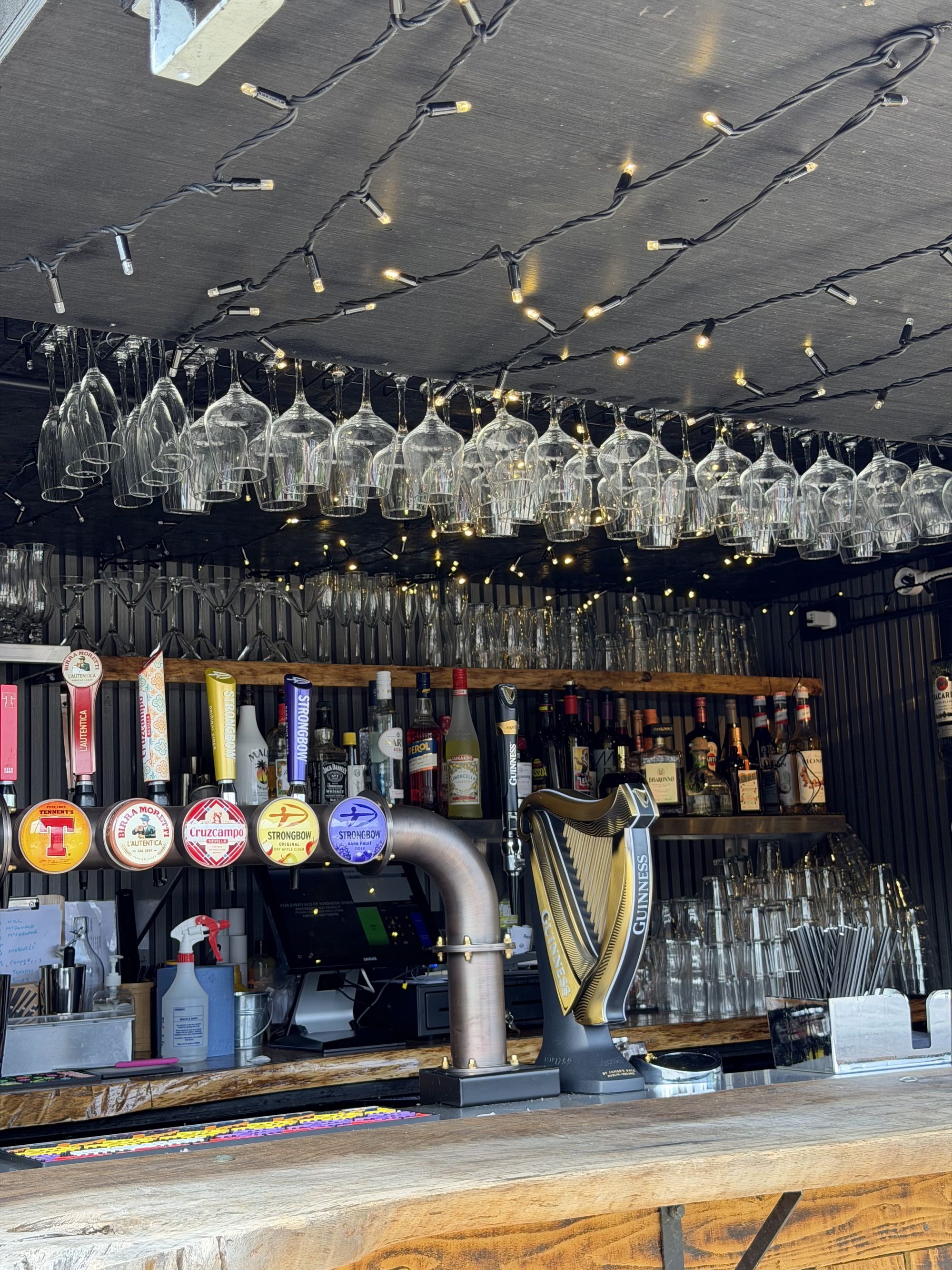 Glassware and festoon lighting above the timber bar