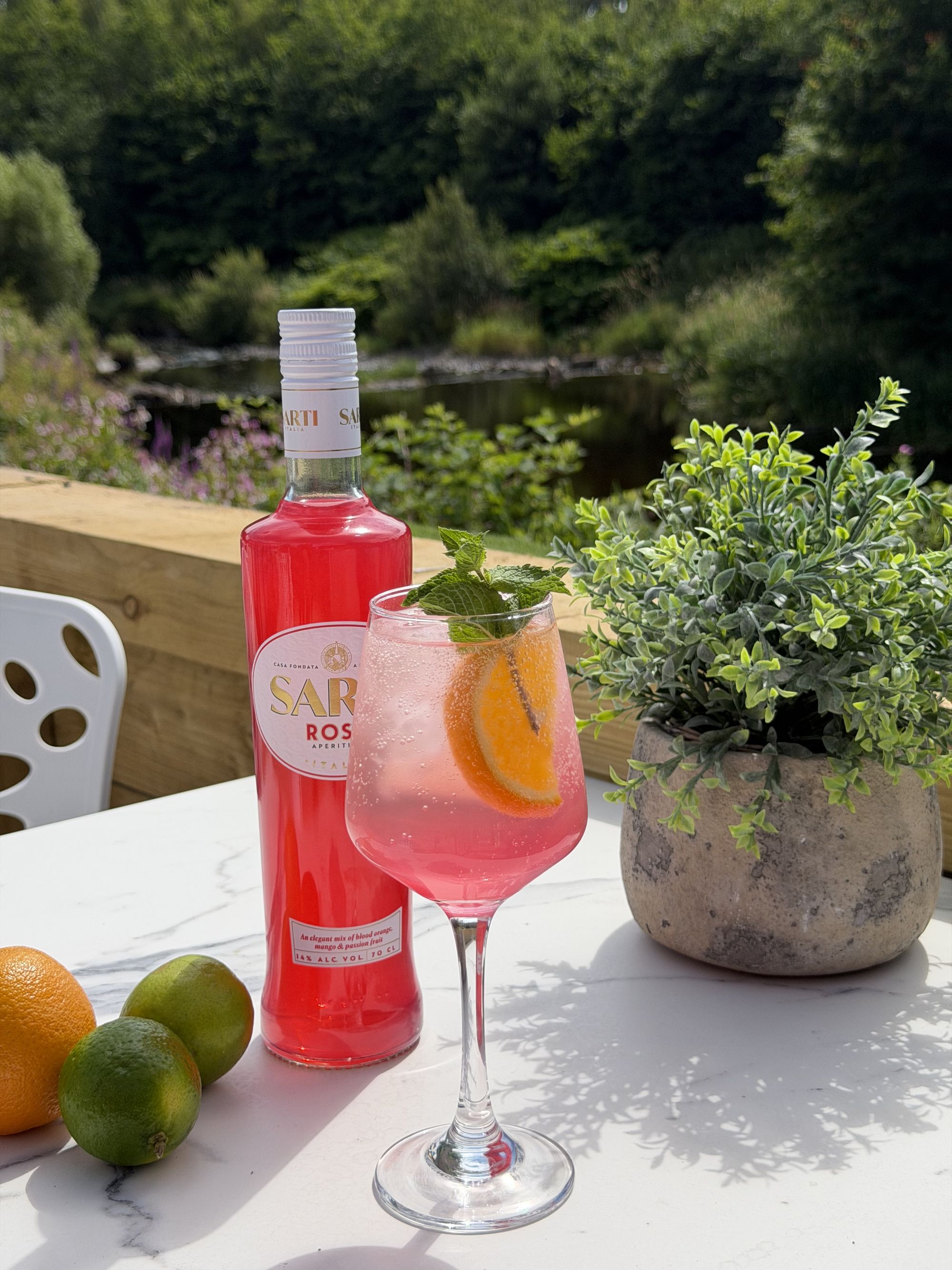 A drink served at a table inside the glasshouse