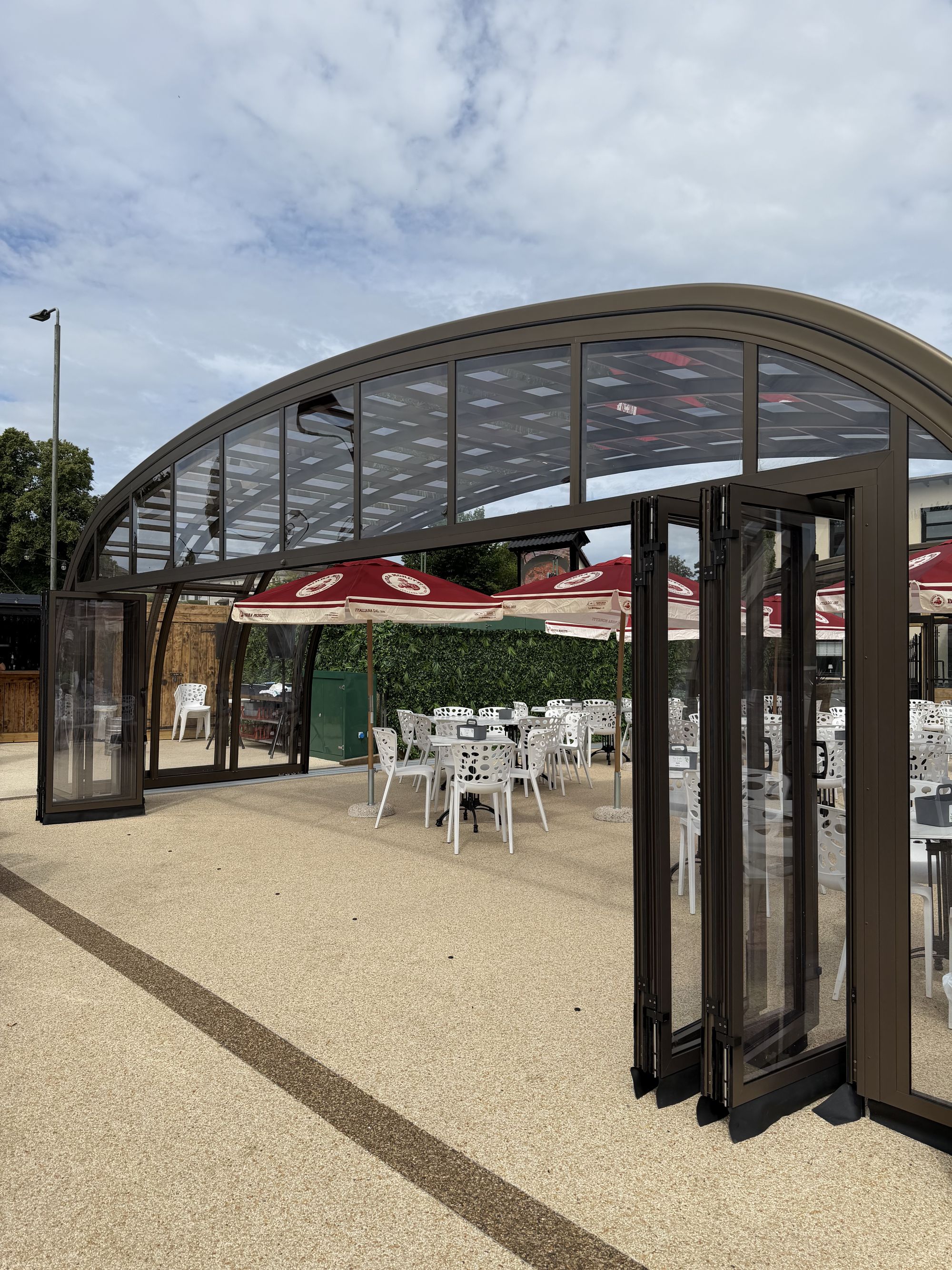 The arched end of the glasshouse with its doors folded open